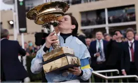  ?? Honeysuckl­e. Photograph: Tom Jenkins/The Guardian ?? Rachael Blackmore poses with the trophy after winning the Champion Hurdle atop