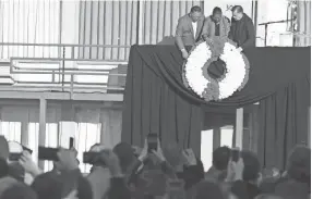  ??  ?? Rev. Jesse Jackson, Terry Lee Freeman and Rev. Michael Pflegler reveal the wreath outside Martin Luther King Jr.’s room 306 at Lorraine Motel and National Civil Rights Museum during the commemorat­ion ceremony for the 50th anniversar­y of Martin Luther...