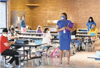  ?? MATT BUTTON/BALTIMORE SUN MEDIA ?? Aberdeen Middle School Principal DeAnn Webb welcomes students Tuesday as they arrive at the Learning Support Center on day one.