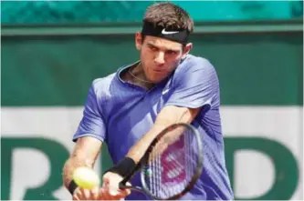  ??  ?? PARIS: Argentina's Juan Martin Del Potro returns the ball to compatriot Guido Pella during their first round match of the French Open tennis tournament at the Roland Garros stadium, yesterday. — AP