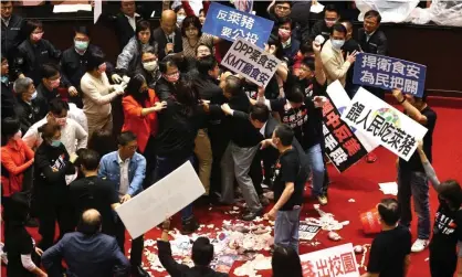  ??  ?? A still image from a video of the scuffle in the parliament in Taipei. Photograph: Ann Wang/Reuters