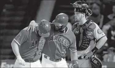  ?? LUIS SINCO/TRIBUNE NEWS SERVICE ?? The Los Angeles Angels' C.J. Cron, left, and Albert Pujols celebrate Cron's sixth-inning two-run home run against the Washington Nationals and catcher Matt Wieters, right, on Wednesday in Anaheim.