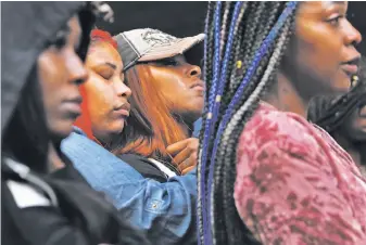  ?? Scott Strazzante / The Chronicle ?? Friends of Nia Wilson mourn during a vigil in memory of the 18-year-old stabbing victim at MacArthur BART Station. The suspect in the slaying fled and was found on a train a day later.