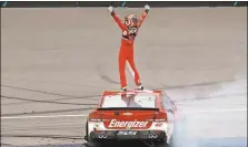  ?? Paul Sancya / The Associated Press ?? Kyle Larson celebrates winning Sunday’s NASCAR Sprint Cup Series race at Michigan Internatio­nal Speedway in Brooklyn, Mich.