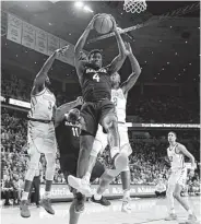  ?? Matthew Putney / Associated Press ?? Mario Kegler, center, pulls down one of Baylor’s 44 rebounds during Tuesday night’s game at Iowa State.