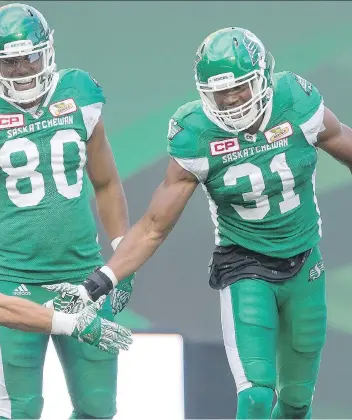  ?? MICHAEL BELL ?? Glenn Love, right, says Saskatchew­an Roughrider­s teammates such as Spencer Moore do a great job with blocking and filling their gaps, allowing Love to make a league-leading number of special-teams tackles.