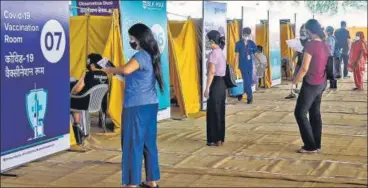  ?? PTI ?? People over 18 years of age wait to receive their first dose of Covid-19 vaccine at the Radha Soami Satsang, in New Delhi on Thursday