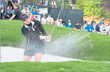  ?? DREW HALLOWELL — GETTY IMAGES ?? Ariya Jutanugarn, who overcame a back-nine collapse to win, chips from the bunker on the fourth playoff hole Sunday.