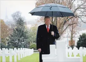  ?? JACQUELYN MARTIN THE ASSOCIATED PRESS ?? U.S. President Donald Trump stands among headstones during a ceremony at Suresnes American Cemetery. Sunday was the 100th anniversar­y of the end of the First World War.