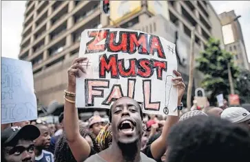  ?? Marco Longari AFP/Getty Images ?? SOUTH AFRICANS call for President Jacob Zuma’s ouster during a protest in Johannesbu­rg in 2015.