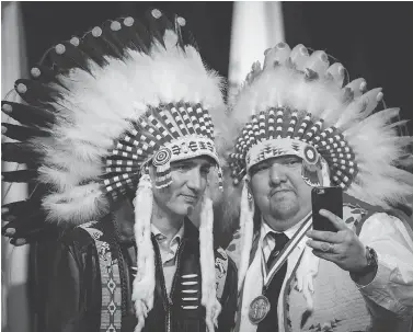  ?? JEFF MCINTOSH / THE CANADIAN PRESS FILES ?? Prime Minister Justin Trudeau poses for a selfie with Tsuut’ina First Nation councillor Emil Starlight near Calgary last March. First Nations leaders have criticized Trudeau for empty displays of showy symbolism instead of action.