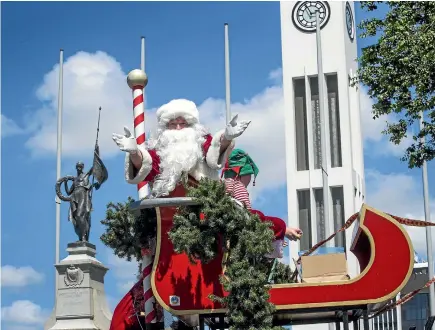  ?? PHOTO: WARWICK SMITH/STUFF ?? Santa and his sleigh was the feature float for the Palmerston North Christmas parade through The Square yesterday.