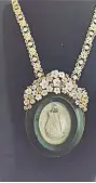  ??  ?? Large framed merschuem carved image of the Blessed Virgin Mary ( from Belgium) accented with mother-of-pearl flowers attached to a vintage gold plated silver alfajor necklace