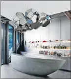  ?? Picture: ELLE DECOR ?? The bar’s island is made of glass fiber–reinforced concrete, and the stainless steel paneling is custom.