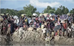  ?? — aFP ?? In limbo: a file photo showing rohingya refugees waiting after crossing the Naf river from Myanmar into Bangladesh in 2017.