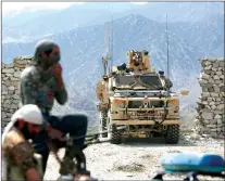  ?? AP PHOTO ?? In this April 17, 2017, photo, U.S. forces and Afghan security police are seen in Asad Khil near the site of a U.S. bombing in the Achin district of Jalalabad, east of Kabul, Afghanista­n.