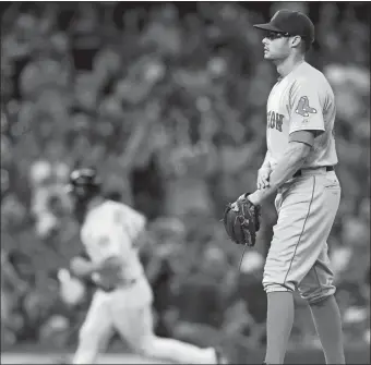  ?? RICHARD CARSON/AP PHOTO ?? Boston pitcher Joe Kelly stands on the mound as Houston’s Evan Gattis rounds the bases on a solo home run during the fourth inning of Wednesday’s game in Houston. The Astros won, 4-2.