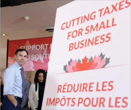  ?? NATHAN DENETTE, THE CANADIAN PRESS ?? Finance Minister Bill Morneau looks on during a press conference in Stouffvill­e on Monday.