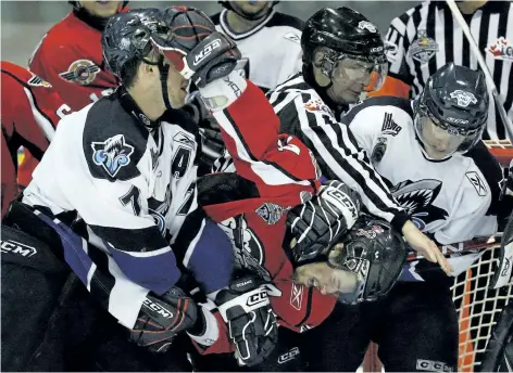  ?? POSTMEDIA FILES ?? Sebastien Piche of the Rimouski Oceanics, left, and Windsor’s Adam Henrique fight during a 2009 Memorial Cup game in Rimouski, Que. The Spitfires fought 110 times en route to their 2009 championsh­ip. This season, Windsor players have squared off only...