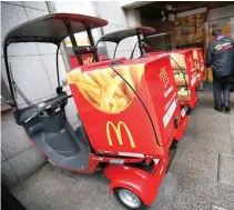  ??  ?? DELIVERY SCOOTERS decorated with pictures of McDonald’s food, including a packet of fries, are pictured outside a McDonald’s store in Tokyo in this file photo taken on Dec. 16, 2014. McDonald’s Corp., the world’s biggest restaurant chain, reported an...