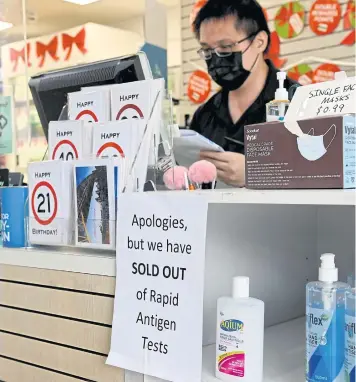  ?? REUTERS ?? A pharmacy displays a sign to inform customers that rapid antigen test kits are sold out in Sydney.