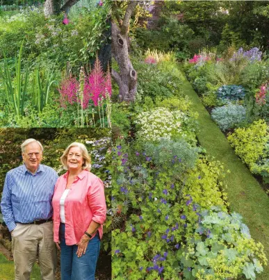  ?? ?? Above: Romy and Tom Holmes, winners of the Garden of the Year Award 2022, have spent decades creating their beautiful garden that brims with a riot of colour