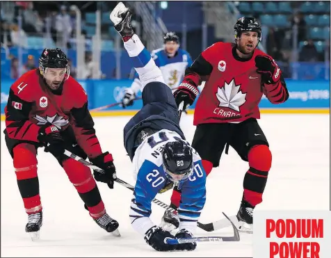  ?? GETTY IMAGES ?? Finnish star Eeli Tolvanen is upended by Chris Lee (4) and Derek Roy of Canada during yesterday’s quarter-final at the Gangneung Hockey Centre.