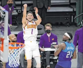  ?? Aaron Gash The Associated Press ?? Devin Booker of the Suns is fouled by the Bucks’ P.J. Tucker, left, setting up Booker’s decisive free throw in a 128-127 victory.
