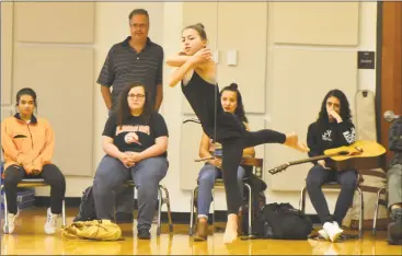  ?? Alex von Kleydorff / Hearst Connecticu­t Media ?? Above, Megan Rodko, of Shelton, uses dance to express her feelings about her family history and Italian culture at the Regional Center for the Arts in Trumbull. At left, Teagan Spitzel, of Bridgeport, reads song lyrics.