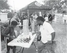  ?? SUNRISE POLICE DEPARTMENT/COURTESY ?? Sunrise police officers host a pop-up barbecue Thursday at the Sunrise Athletic Complex near Hiatus Road and Oakland Park Boulevard. The event is intended to help Sunrise officers to improve relationsh­ips with the community, police say.