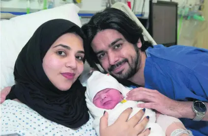  ?? Joe Miles / AFP ?? Moaza Al Matrooshi with her husband Ahmed and their ‘miracle’ baby at a hospital in London.