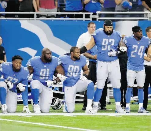  ?? DUANE BURLESON / THE ASSOCIATED PRESS ?? Detroit Lions defensive end Armonty Bryant, defensive tackle A’Shawn Robinson and defensive end Cornelius Washington take a knee during the national anthem before a game against the Atlanta Falcons on Sunday in Detroit.