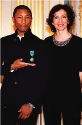  ??  ?? US singer Pharrell Williams poses with French culture minister Audrey Azoulay, right, after being awarded with the medal of Knight of the Order of Arts and Letters during a ceremony at the culture ministry in Paris, France.