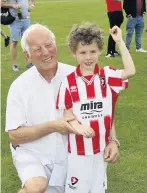  ??  ?? Richard Pye, who has held a Cheltenham Town FC season ticket for over 20 years, with his grandson Theo, six, a new fan