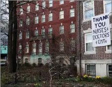  ?? MADDIE MEYER — GETTY IMAGES ?? A sign of support for nurses, doctors, and EMTs hangs on a home near Mass General Hospital in April 2020 during the coronaviru­s (COVID-19) outbreak.