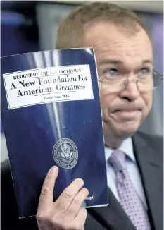  ?? ANDREW HARNIK/AP PHOTO ?? Budget Director Mick Mulvaney holds up a copy of President Donald Trump’s proposed fiscal 2018 federal budget as he speaks to members of the media in the Press Briefing Room of the White House in Washington, Tuesday.