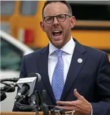  ?? STuART CAHiLL pHOTOs / HERALd sTAFF ?? ‘INCREDIBLY DIFFICULT’: Revere Mayor Brina Arrigo announces that municipal events, including Tuesday’s high school graduation, have been called off because of increased virus cases. Left, samples are taken at a drive-thru COVID-19 testing site in the city.