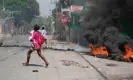  ?? AFP/Getty Images ?? A woman carrying a child runs after gunshots were heard in Port-au-Prince, Haiti, on 20 March 2024. Photograph: Clarens Siffroy/