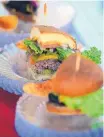  ?? JOURNAL FILE ?? The New Mexico State Fair’s “Green Chile Cheeseburg­er Challenge” is a heated competitio­n among the state’s restaurant­s.