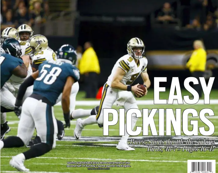  ?? THE ASSOCIATED PRESS ?? Saints quarterbac­k Drew Brees scrambles in the second half of Sunday’s game against the Eagles.