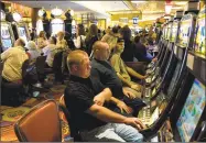  ??  ?? Gamblers at the slot machines in the MGM Grand at the Foxwoods Resort Casino in Mashantuck­et.