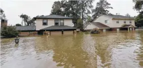  ?? THE ASSOCIATED PRESS ?? Floodwater­s from Tropical Storm Harvey surround homes Monday in Spring, Texas.