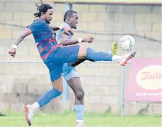  ?? GLADSTONE TAYLOR ?? Waterhouse’s Javane Bryan (right) and Dunbeholde­n’s Kevin Graham compete for possession in their Jamaica Premier League fixture at the Drewsland Mini-Stadium yesterday. Waterhouse won 1-0.