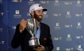  ?? FRANK FRANKLIN II - THE ASSOCIATED PRESS ?? Dustin Johnson poses with the trophy after winning the Travelers Championsh­ip golf tournament at TPC River Highlands, Sunday, June 28, 2020, in Cromwell, Conn.