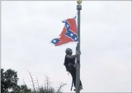  ?? BRUCE SMITH/ ASSOCIATED PRESS ?? Bree Newsome, of Charlotte, North Carolina, climbs a flagpole to remove the Confederat­e flag at a monument in front of the Statehouse in Columbia, South Carolina, on Saturday. She was taken into custody when she came down. The flag was raised again...