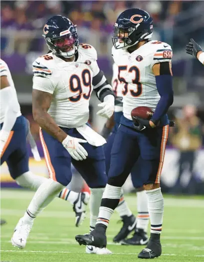  ?? STACEY WESCOTT/CHICAGO TRIBUNE ?? Bears linebacker T.J. Edwards, right, celebrates with defensive tackle Gervon Dexter Sr., left, after making an intercepti­on against the Vikings on Nov. 27 at U.S. Bank Stadium in Minneapoli­s.