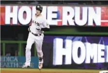  ?? Lynne Sladky / Associated Press ?? Brian Anderson of the Marlins circles the bases after his fourth-inning home run. He later added two doubles.