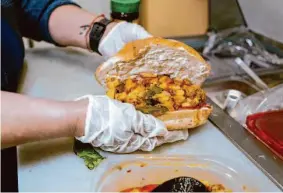  ?? ?? A peek inside the chorizo con papas torta from Pena’s Bakery in Oakland. Chef Maria De La Luz Briones uses traditiona­l telera bread from the panaderia.