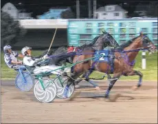  ?? JASON SIMMONDS/JOURNAL PIONEER ?? The Kenny Arsenault-driven Czar Seelster edges out Euchred, driven by Adam Merner, to win the 50th running of the Governor’s Plate in 1:53.2 at Red Shores at Summerside Raceway on Saturday night.