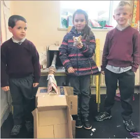  ?? ?? LEFT - Shane and Clodagh with their marble run using gravitatio­nal drops.
ABOVE - Seán, Isabelle and Brian with their marble run, investigat­ing slopes.